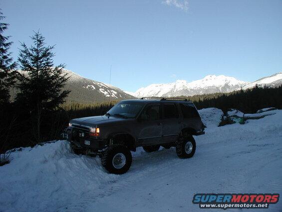 Lifted SUV in a snowy mountain landscape