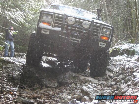 1985 Ford Bronco on a rocky, snowy trail.
