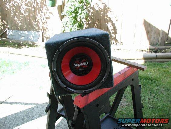Sony Xplod subwoofer with red cone on a sawhorse