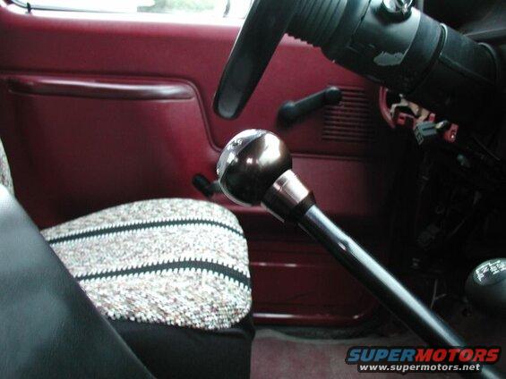 Close-up of a shiny gear shifter knob in a vintage truck interior.