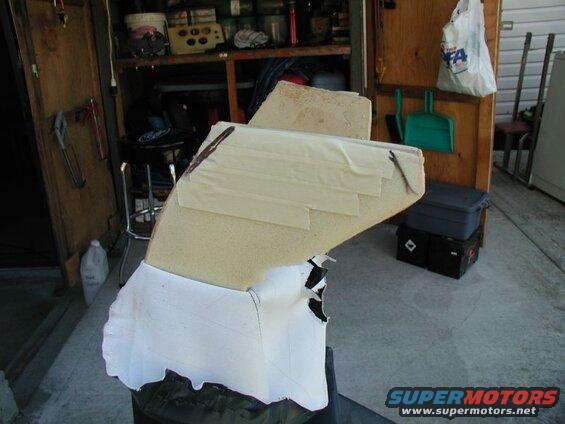 Custom foam seat padding covered in white fabric with tape.