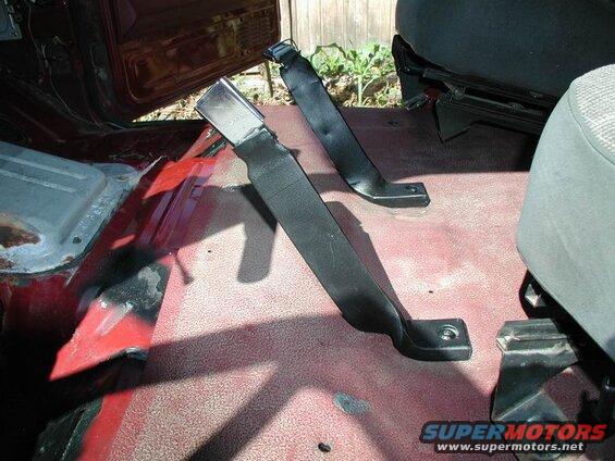 Interior of a 1990 Ford F-250 pickup truck showing floor-mounted seatbelts.