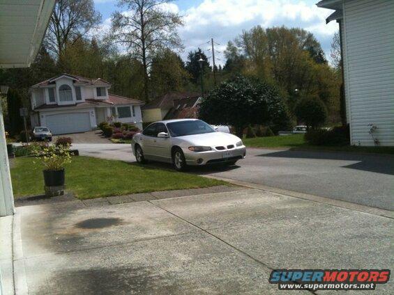 Silver 2002 Pontiac Grand Prix parked on street.
