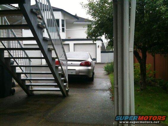 Silver 2002 Pontiac Grand Prix parked in a driveway, rear view.