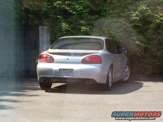 Silver 2002 Pontiac Grand Prix, rear view, showing dual exhaust and license plate 518-NEP.