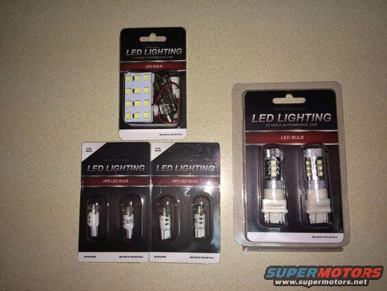 Four packages of Diode Dynamics LED automotive lighting bulbs on a speckled countertop.