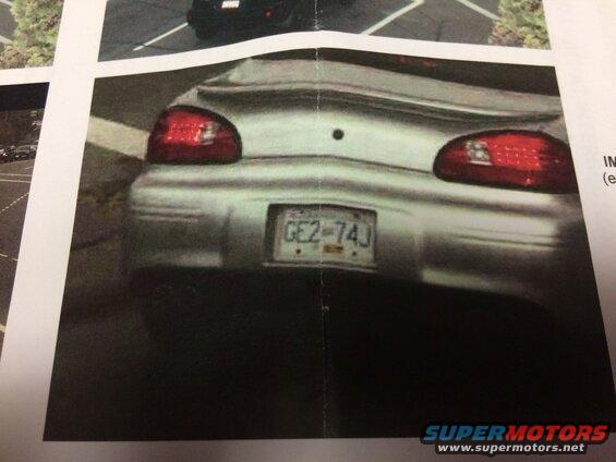 Rear view of a silver 2002 Pontiac Grand Prix with license plate GE2-74J
