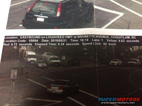 Rear view of a black SUV with a traffic camera information document overlaid.