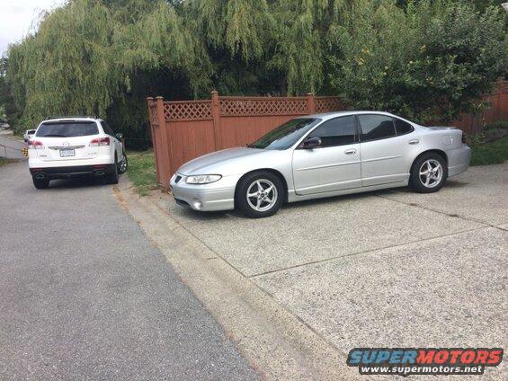 Silver Pontiac Grand Prix parked on a driveway.