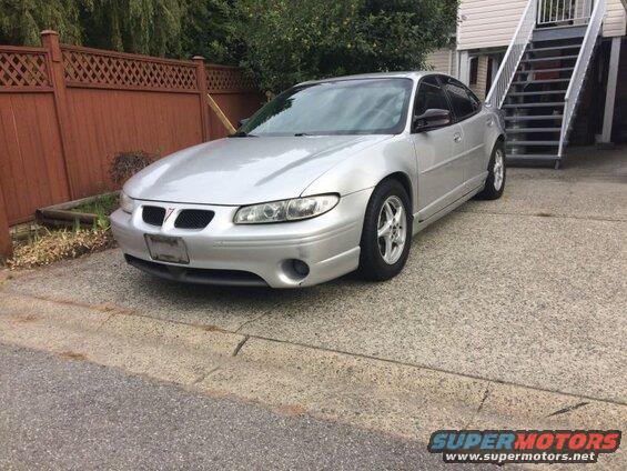 Silver 2002 Pontiac Grand Prix parked on a driveway.
