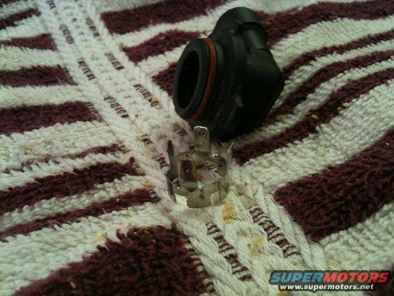 Black electrical connector and silver metal part on a striped towel