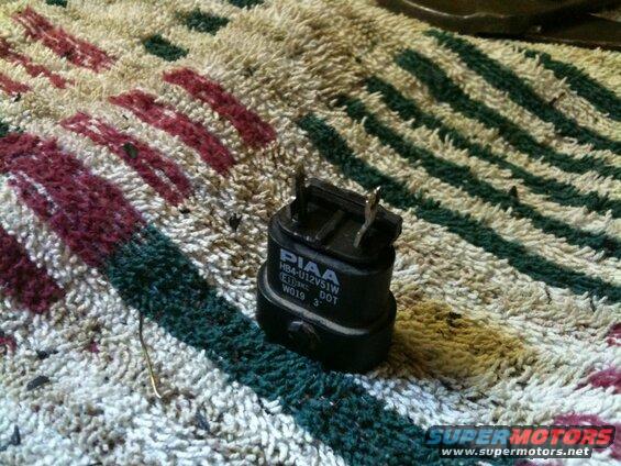 Black PIAA HB4U12V51W light bulb base with text on a rug.