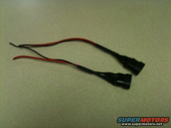 Two black electrical connectors with red and black wires