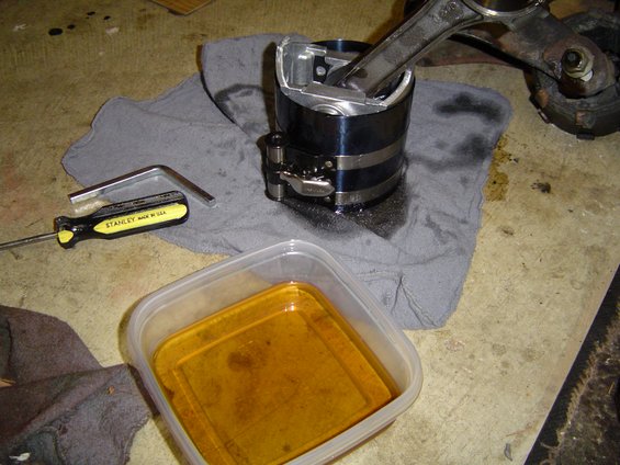 engine-reassembly-056.jpg Pistons are dipped in oil, then the compressor is put on