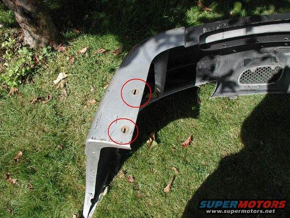 7mm screw on the lower corners of the bumper.