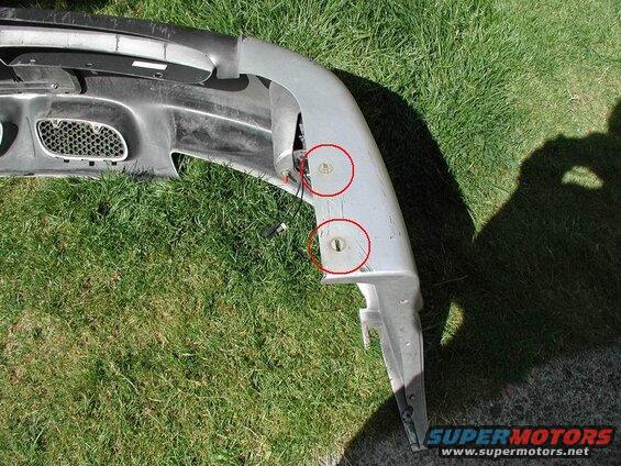 7mm screw on the lower corners of the bumper.
