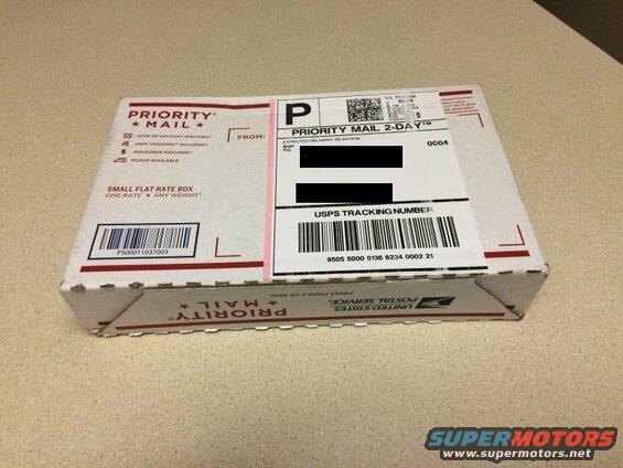 USPS Priority Mail small flat rate box with tracking number and postage.