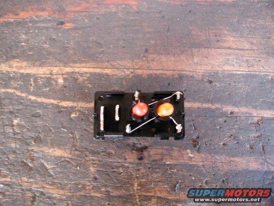 Unsolder the orange bulb from the hi beam +/- terminal and solder it to the red bulb - terminal.