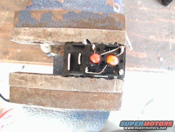 Unsolder the orange bulb from the hi beam +/- terminal and solder it to the red bulb - terminal.