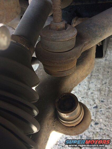 Rusted automotive ball joint with torn rubber boot
