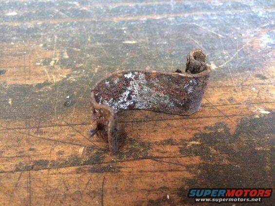 Rusty metal bracket on a wooden surface