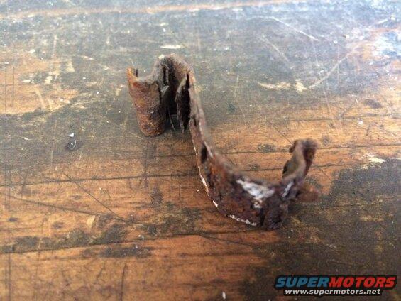 Rusted metal bracket on a wooden surface