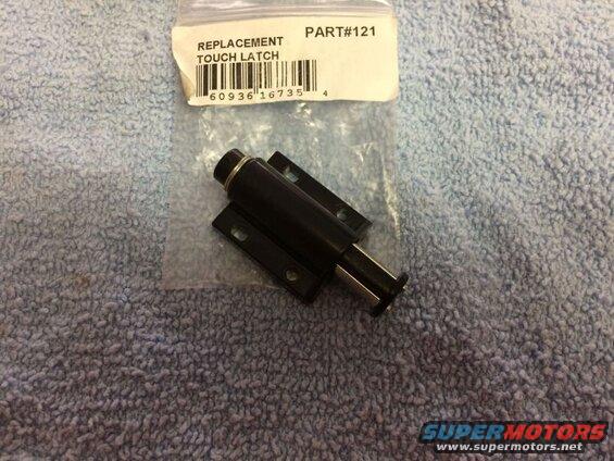 Black replacement touch latch with part number label on blue textured surface.