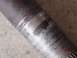 1987 Ford Bronco - Metal shaft with visible wear marks and staining, likely a component from a vehicle.