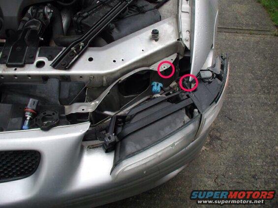 Silver car fender and headlight assembly with visible internal components and mounting hardware.