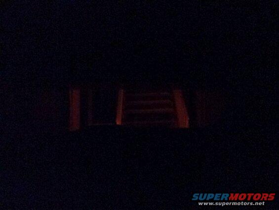 Looking out the back window from the drivers seat; brake lights on.