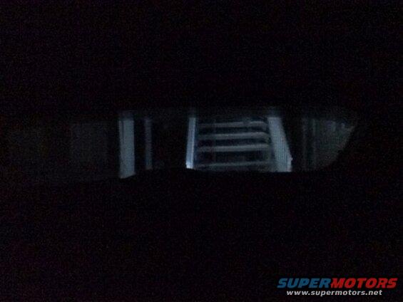 Looking out the back window from the drivers seat; reverse lights on.