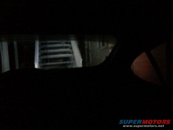 Looking out the back window from the drivers seat; reverse lights on.