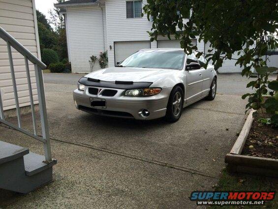 Silver 2002 Pontiac Grand Prix with bug deflector parked in driveway.