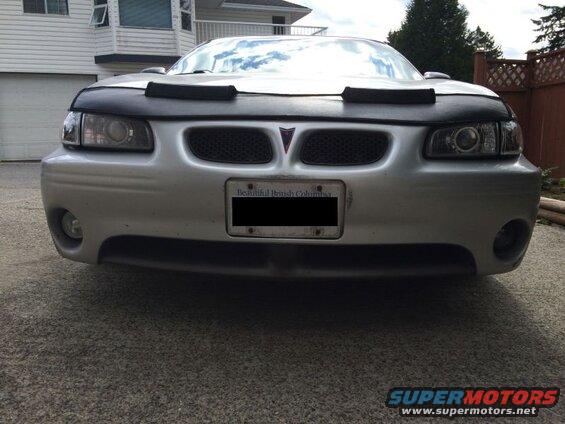 Silver 2002 Pontiac Grand Prix front view with black car bra and license plate.