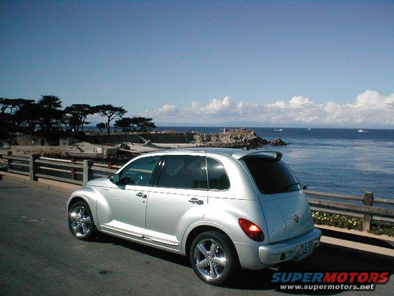 Silver 2004 Chrysler PT Cruiser parked on a road overlooking the ocean