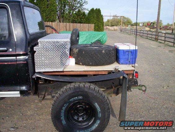 Truck bed with spare tire, cooler, and toolbox