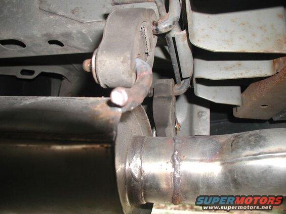 2002 Pontiac Grand Prix exhaust system with muffler and rusted hangers.