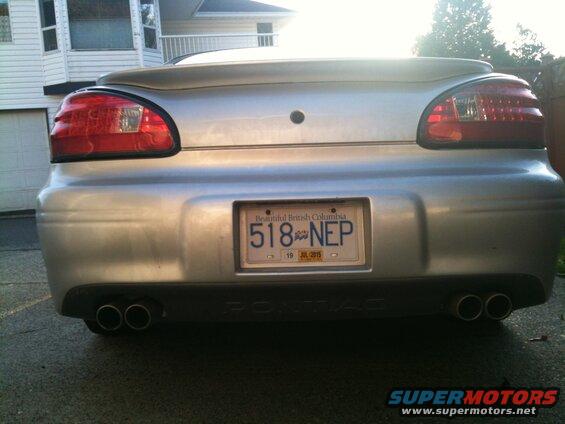 Rear view of a silver 2002 Pontiac Grand Prix with dual exhaust and BC license plate 518-NEP.