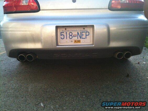 Rear view of a silver 2002 Pontiac Grand Prix with dual exhaust and BC license plate 518 NEP.