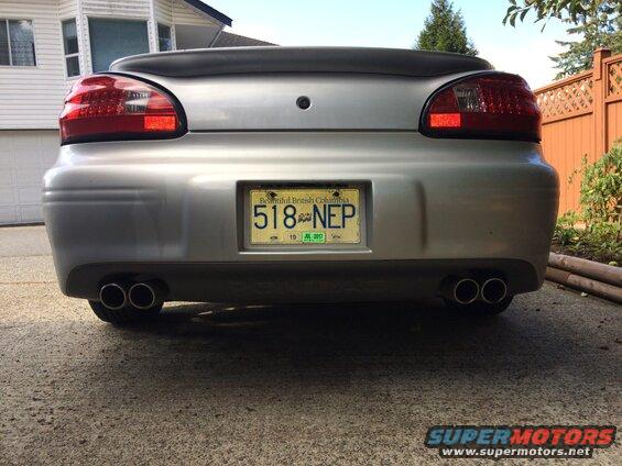 Rear view of a silver 2002 Pontiac Grand Prix with dual exhaust and BC license plate 518 NEP.