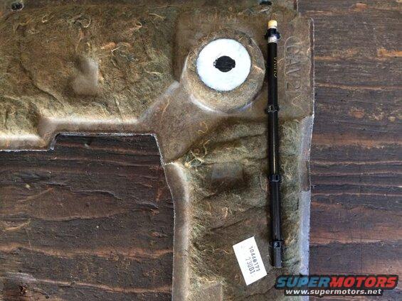 Underside of a car part with insulation and a black plastic component labeled CHINA.