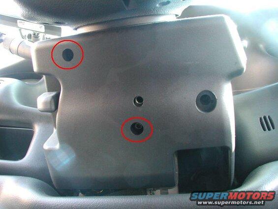 Tilt the steering column up and remove the two torx bolts holding the lower part of the steering column cover together.