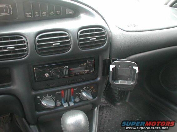 Car dashboard interior with JVC stereo, climate controls, and phone holder.