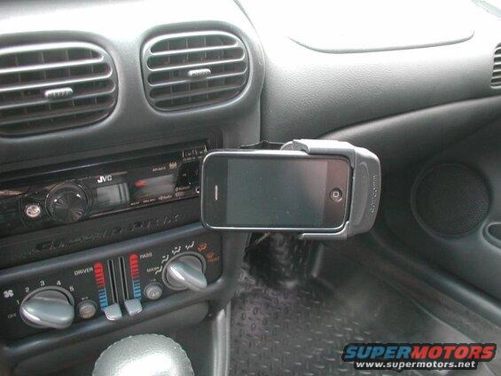 iPhone mounted on car dashboard next to JVC stereo and climate controls.