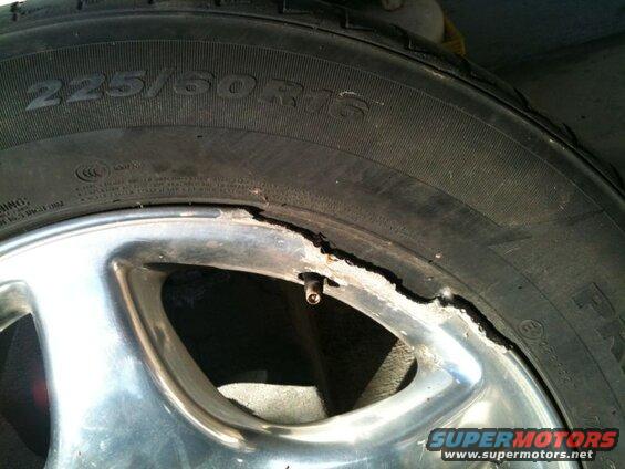 Damaged tire and chrome rim with size 225/60R16 visible.