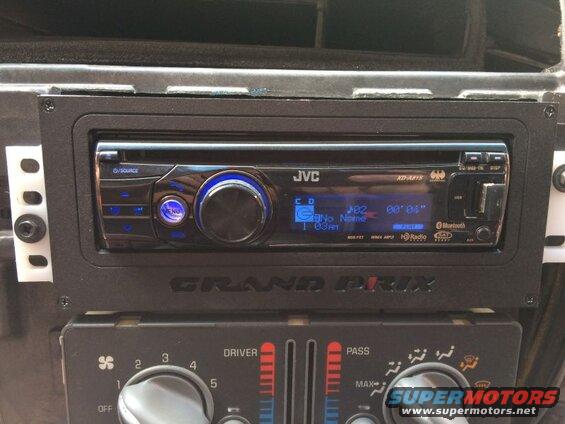 JVC KD-A815 car stereo and climate controls in a vehicle dashboard.