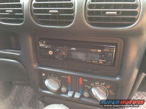 Car interior dashboard with JVC stereo and climate controls.