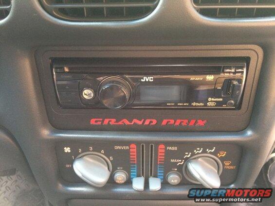 2002 Pontiac Grand Prix interior center console with JVC stereo and climate controls.