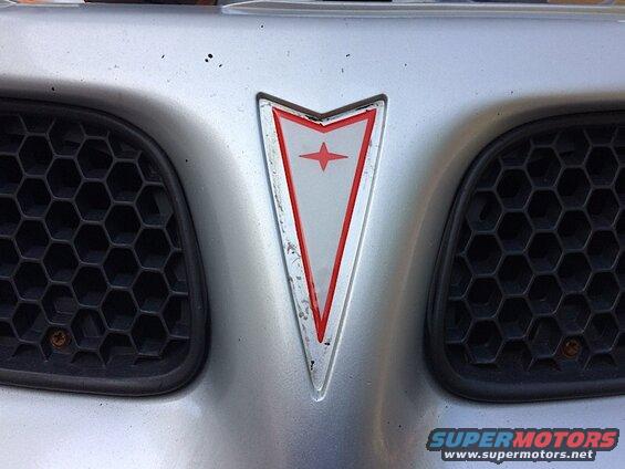 Silver Pontiac Grand Prix front grille and emblem