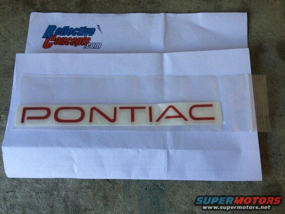 Red Pontiac emblem sticker on white paper with ReflectiveConcepts.com logo.